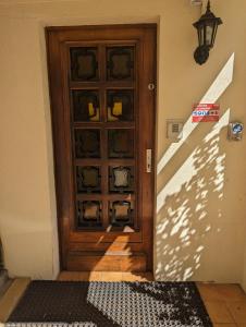 a wooden door with a shadow on the wall at Auberge Des Pins in Aubenas