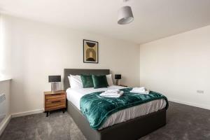 a bedroom with a large bed and a night stand at Stylish 1 Bed Apartment in Central Retford in Retford