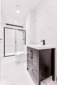 a white bathroom with a sink and a toilet at Spacious 2 Bed Apartment in Burton-on-Trent in Burton upon Trent