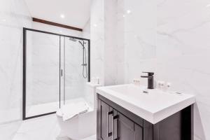 a white bathroom with a sink and a shower at Spacious 2 Bed Apartment in Burton-on-Trent in Burton upon Trent