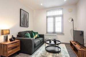 a living room with a couch and a tv at Fantastic 1 Bed Budget Apartment in Doncaster in Doncaster