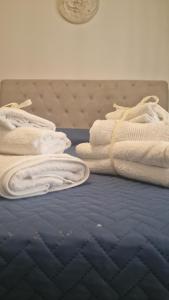 a pile of towels sitting on top of a bed at Costa rooms apartament in Livorno