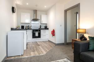 a kitchen and living room with a white refrigerator at Smart 1 Bed Budget Apartment in Central Doncaster in Doncaster