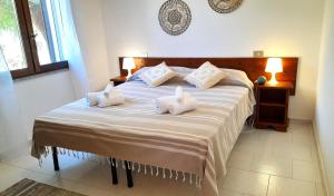 Postel nebo postele na pokoji v ubytování Ferienhaus Casa Mirto - Villaggio Galanu