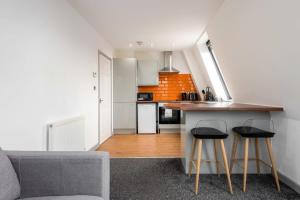 a kitchen with a counter and two stools at Modern 1 Bed Budget Apartment in Central Halifax in Halifax