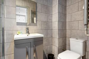 a bathroom with a sink and a toilet at Modern 1 Bed Budget Apartment in Central Halifax in Halifax