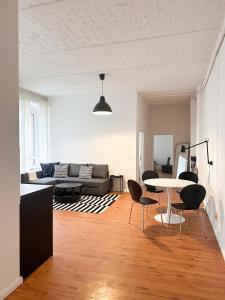 a living room with a couch and a table at NOOK Design Apartments with Kitchen in Berlin