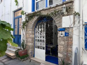 an entrance to a house with a blue door at White and Blue Bodrum in Bodrum City
