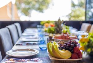a table with a bunch of fruit on it at Olbios Marina Resort Hotel in Kumkuyu