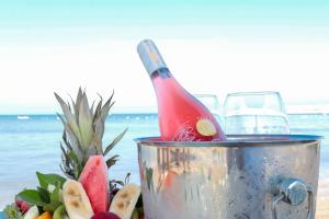 a bottle of champagne in a ice bucket on the beach at Olbios Marina Resort Hotel in Kumkuyu