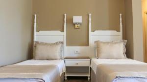 two beds sitting next to each other in a room at Olbios Marina Resort Hotel in Kumkuyu