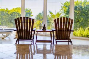 two chairs and a table in a room with a window at Olbios Marina Resort Hotel in Kumkuyu
