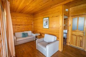 two chairs in a room with wooden walls and wooden floors at Olbios Marina Resort Hotel in Kumkuyu