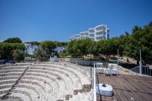 an amphitheater with chairs and a building in the background at Olbios Marina Resort Hotel in Kumkuyu