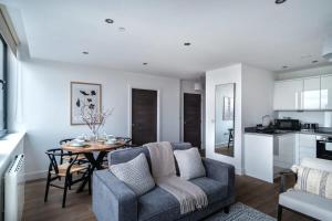 a living room with a couch and a table at Lovely Modern 1 Bed Apartment by Old Trafford in Manchester