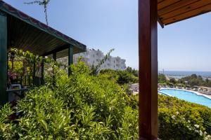 a view from the balcony of a resort with a swimming pool at Olbios Marina Resort Hotel in Kumkuyu