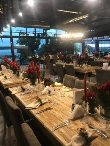 a long wooden table in a room with chairs at Olbios Marina Resort Hotel in Kumkuyu
