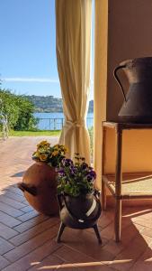 a vase with flowers in it sitting on a porch at La casa sul lago in Trevignano Romano