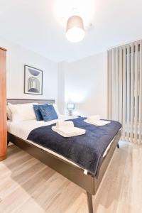 a bedroom with a bed with two towels on it at Lovely Central Birmingham 2 Bed Apartment in Birmingham