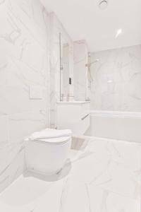 a white bathroom with a toilet and a sink at Lovely Central Birmingham 2 Bed Apartment in Birmingham