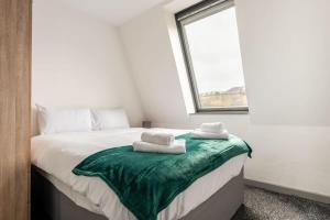 a bedroom with a bed with two towels on it at Smart 1 Bed Budget Apartment in Central Halifax in Halifax