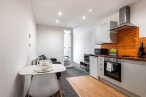 a kitchen with a white table and a counter top at Smart 1 Bed Budget Apartment in Central Halifax in Halifax