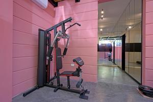 a gym with a pink wall at Comfy apart hotel in Beirut