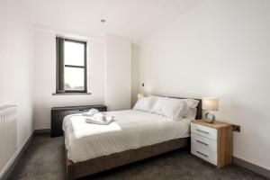 a bedroom with a bed and a window at Modern 1 Bedroom Budget Apartment in Barnsley in Barnsley