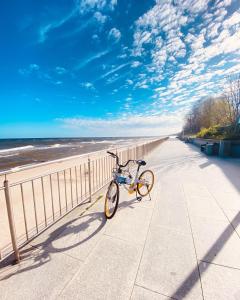 a bike parked on a sidewalk near the beach at SAND Sarbinowo in Sarbinowo