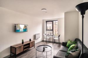 a living room with a couch and a table at Smart 1 Bedroom Apartment in Liverpool Centre in Liverpool