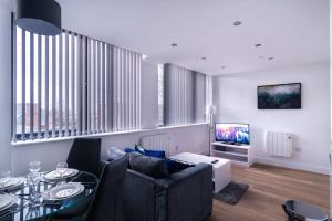 a living room with a couch and a table at Spacious 1 Bed Old Trafford Apartment in Manchester