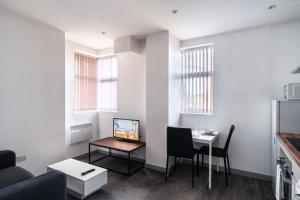 a living room with a couch and a table at Smart 1 Bedroom Apartment in Blackburn in Blackburn