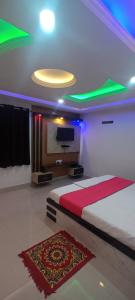 a bedroom with a bed and a flat screen tv at Hotel Raxaul King in Raxaul