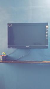 a computer monitor sitting on top of a shelf at Ruchika's Orchid in Hyderabad