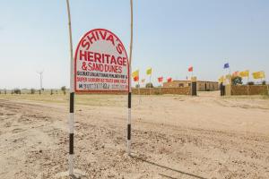 a sign in the middle of a dirt road at Collection O Shivas Heritage in Sām