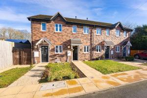 a brick house with a driveway in front of it at Modern 2 Bedroom House in Wolverhampton in Wolverhampton