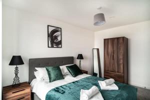 ein Schlafzimmer mit einem großen Bett mit grüner Bettwäsche in der Unterkunft Smart 1 Bedroom Apartment in Central Preston in Preston