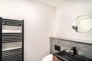 a bathroom with a black sink and a mirror at Stunning 2 Bedroom Apartment in Central Preston in Preston