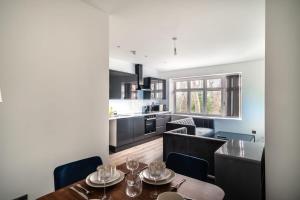 a kitchen and living room with a table and chairs at Spacious 2 Bed Apartment in Waterloo Liverpool in Waterloo