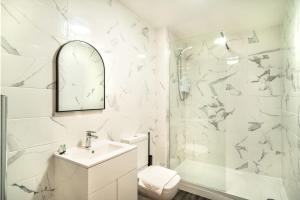 a white bathroom with a sink and a shower at Spacious 2 Bed Apartment in Waterloo Liverpool in Waterloo
