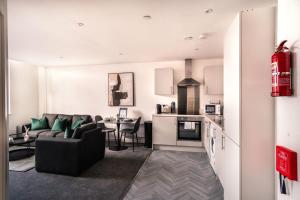 a living room and kitchen with a couch and a table at Contemporary 1 Bed Apartment in Central Preston in Preston +8 photos