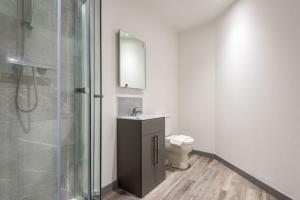 a bathroom with a shower and a sink and a toilet at Lovely 1 Bed Budget Apartment in Central Doncaster in Doncaster