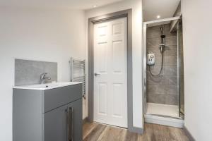 a bathroom with a sink and a shower at Smart Budget Studio Apartment in Central Doncaster in Doncaster