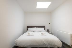 a bedroom with a white bed with two towels on it at Centrally Located Budget 1 Bed Flat in Darlington in Darlington