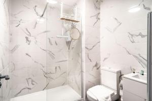 a white bathroom with a shower and a toilet at Modern 2 Bed Apartment in Waterloo Liverpool in Liverpool