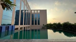 a building with a swimming pool in front of a building at Grand Madurai by GRT Hotels in Madurai