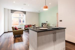 a kitchen with a large island in a room at Characterful 2 Bed Apartment with Parking in Central Hull in Hull
