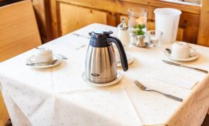 a tea kettle is sitting on a table at Hotel Friese-up AnnerSiet- in Norderney