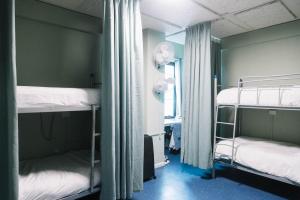 a room with two bunk beds and a window at CarricHostel in Melbourne