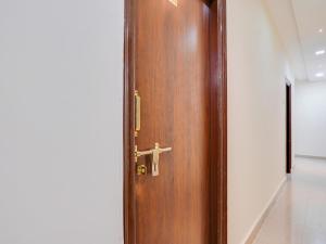 een houten deur met een kruis erop bij Collection O MS Grand Inn in Hyderabad